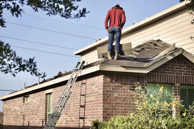 Professional roofer working on a residential roof in Camp Green Eyrie